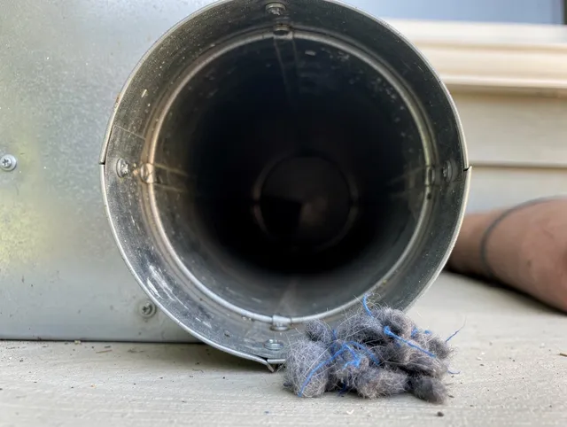 Claremont Dryer Vent Cleaning technician using specialized equipment to clear severe dryer vent blockage in Claremont